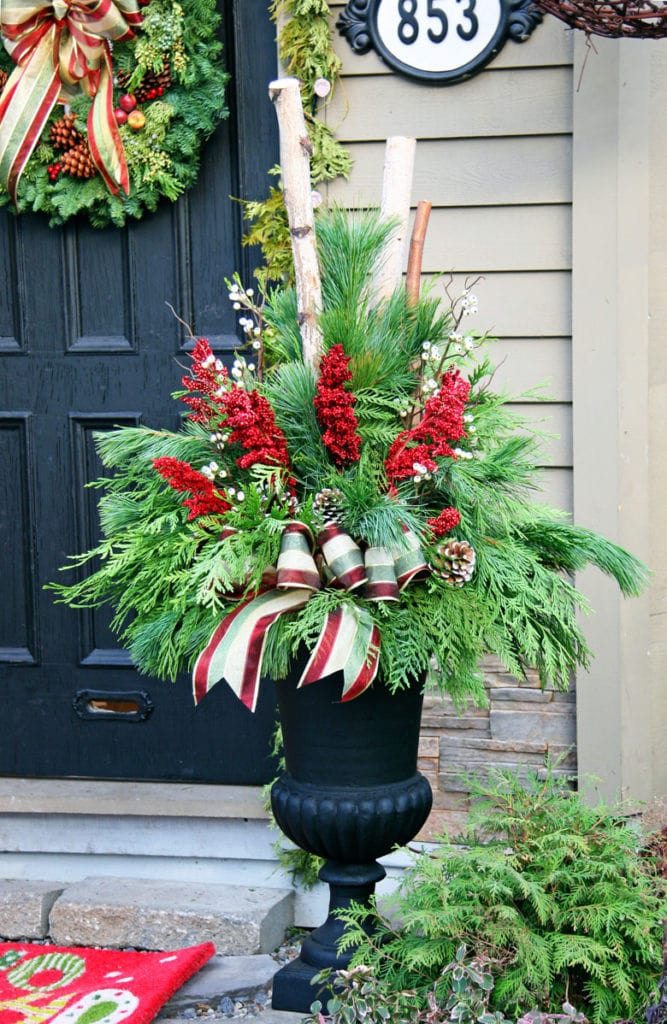 Christmas porch planter using ribbons and pine cones