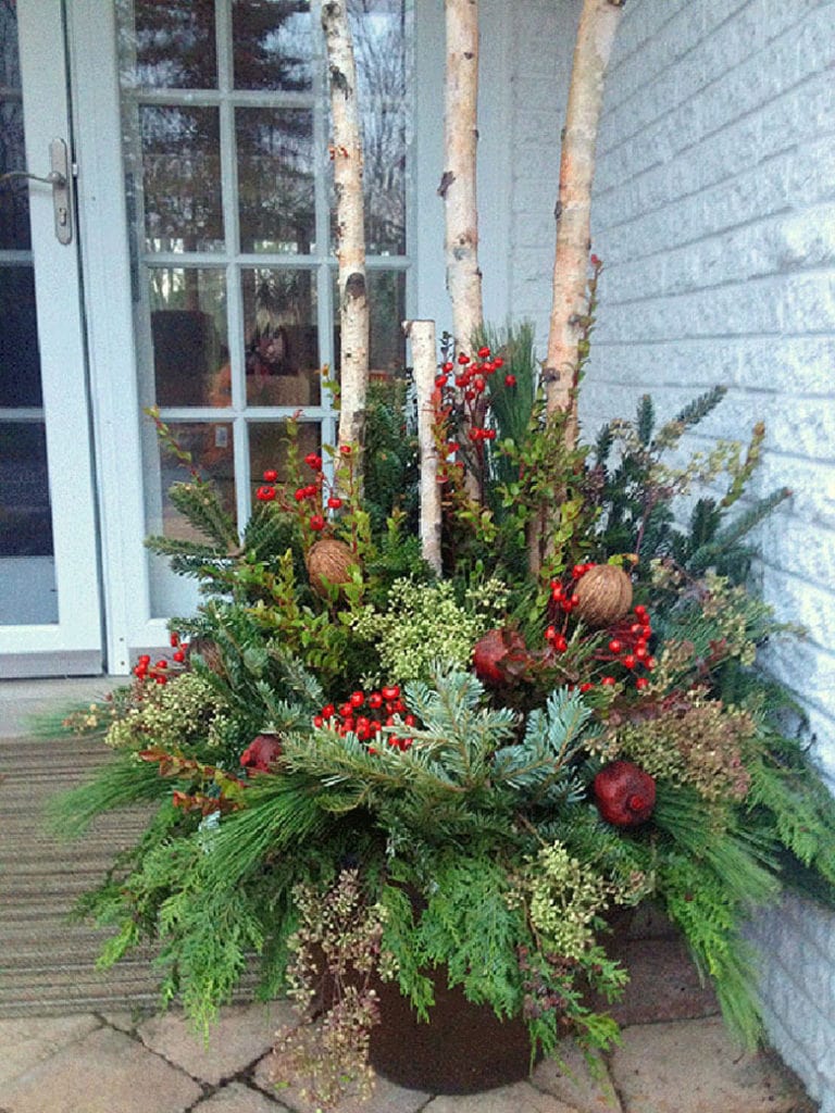 mixed arrangements in a winter pot on the porch