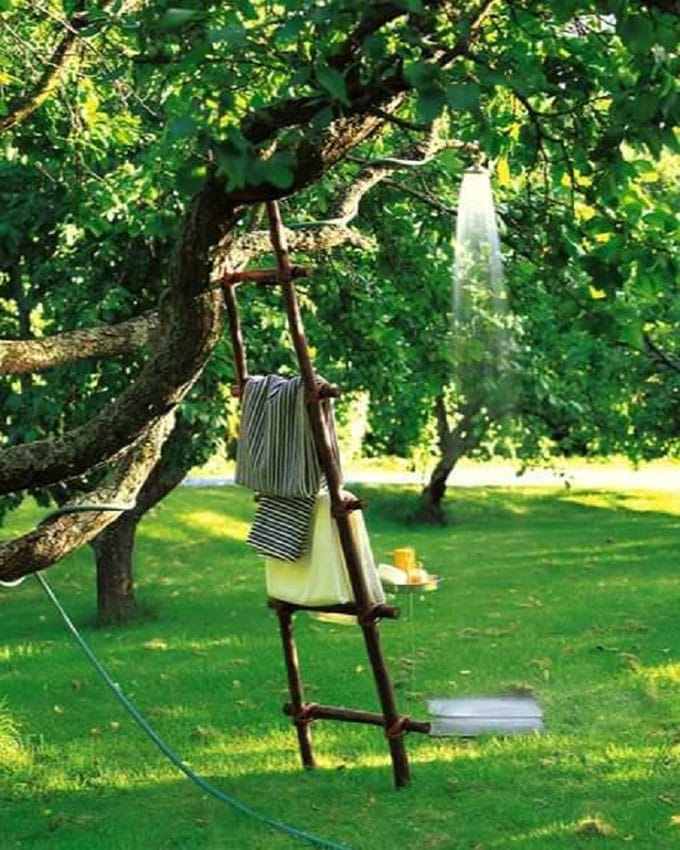 old tree and a hose as shower fixtures, and a tower ladder