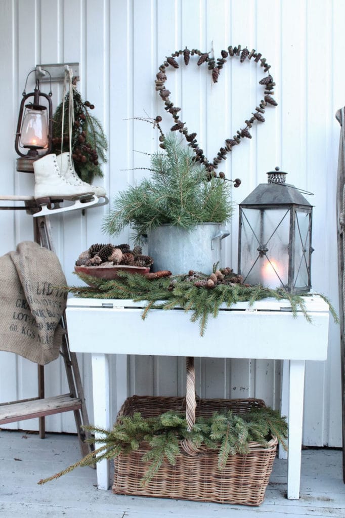 A rustic ladder is transformed into a Christmas display shelf