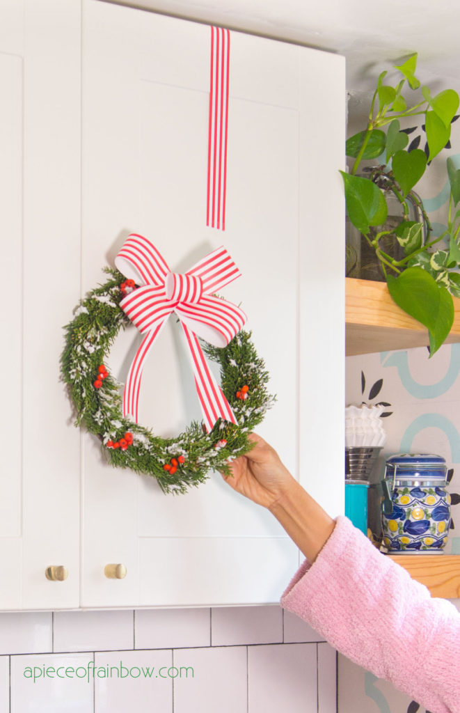 https://www.apieceofrainbow.com/wp-content/uploads/2021/12/DIY-christmas-kitchen-cabinet-decorations-wreath-easy-crafts-farmhouse-kitchen-ideas-modern-boho-ribbon-cardboard-paper-apieceofrainbow-8-661x1024.jpg